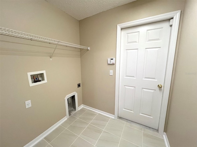 washroom featuring electric dryer hookup, light tile patterned floors, hookup for a washing machine, and a textured ceiling