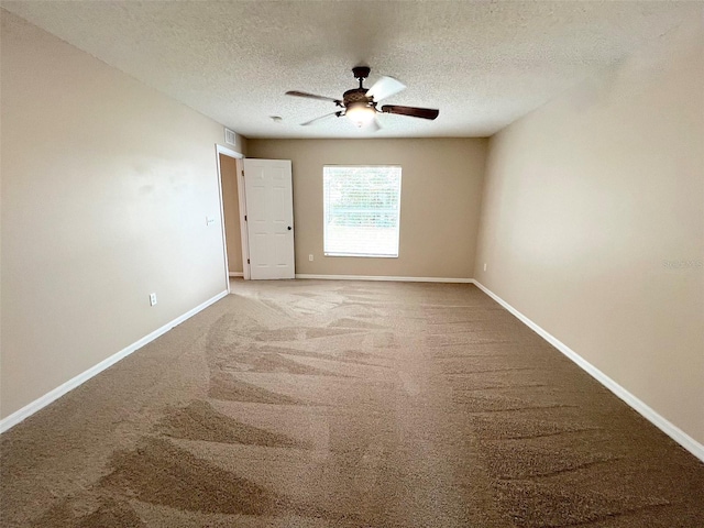 unfurnished room featuring ceiling fan, carpet floors, and a textured ceiling