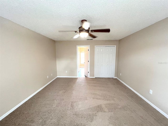 unfurnished bedroom with ceiling fan, carpet floors, a closet, and a textured ceiling