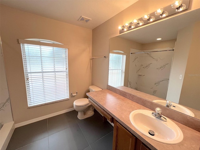 bathroom with vanity, tile patterned flooring, toilet, and walk in shower