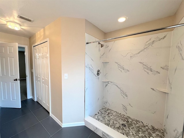 bathroom featuring a tile shower and tile patterned floors