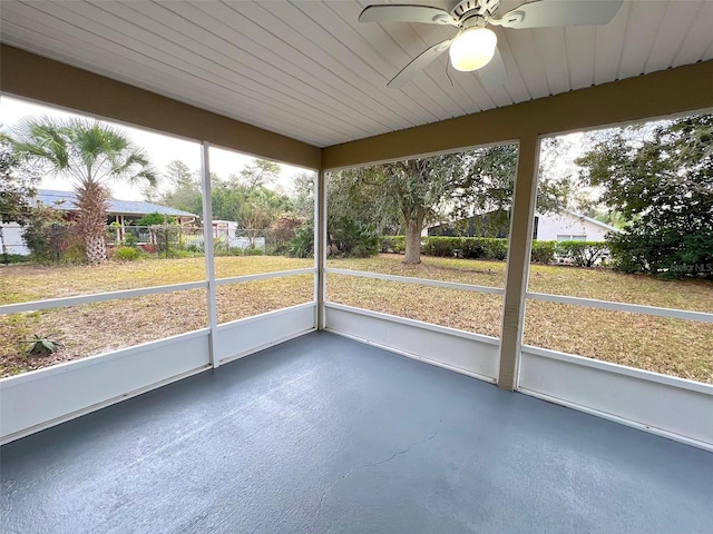 unfurnished sunroom with ceiling fan