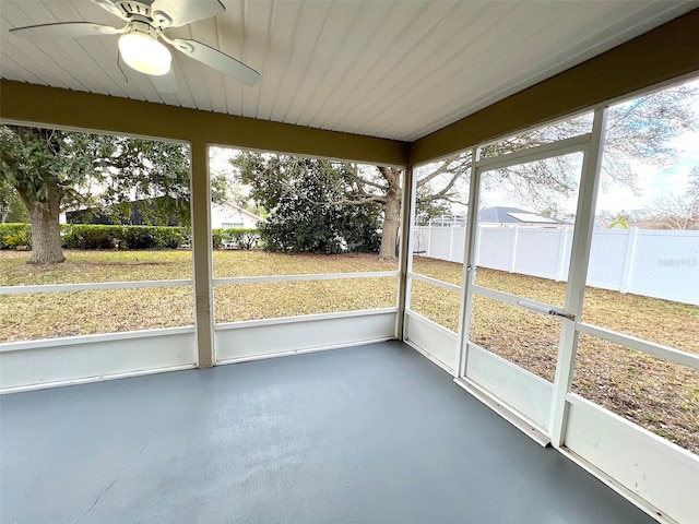 unfurnished sunroom with ceiling fan