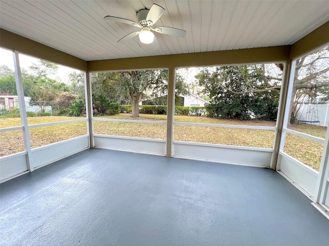 unfurnished sunroom with ceiling fan