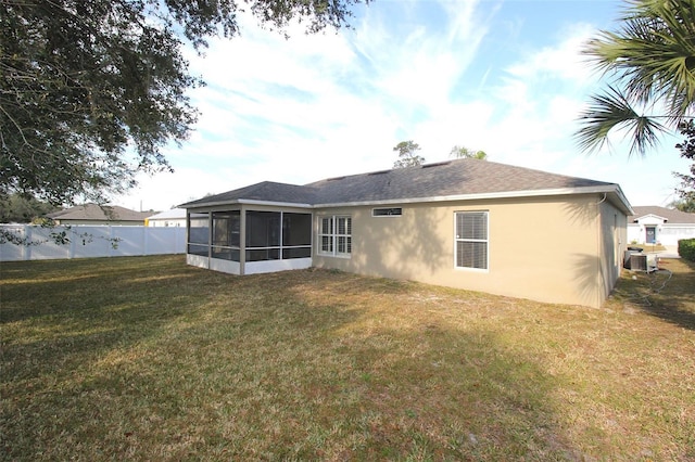 back of house with cooling unit, a yard, and a sunroom