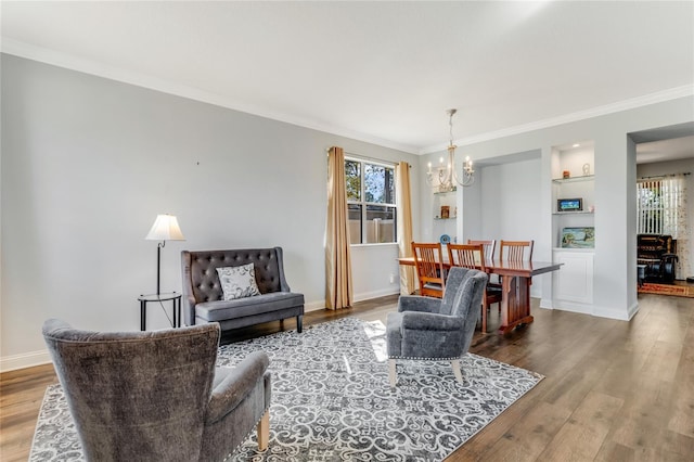 living room with hardwood / wood-style floors, a notable chandelier, and plenty of natural light