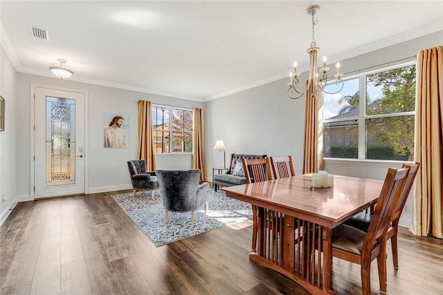 dining space with crown molding, dark hardwood / wood-style floors, and a notable chandelier