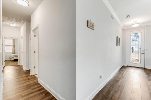 foyer featuring crown molding and dark hardwood / wood-style flooring