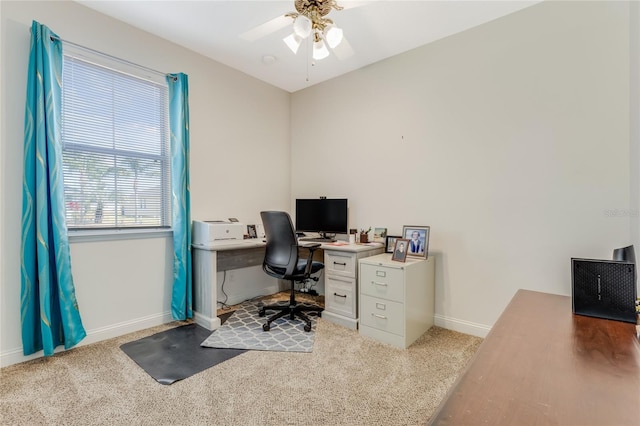 carpeted home office with ceiling fan