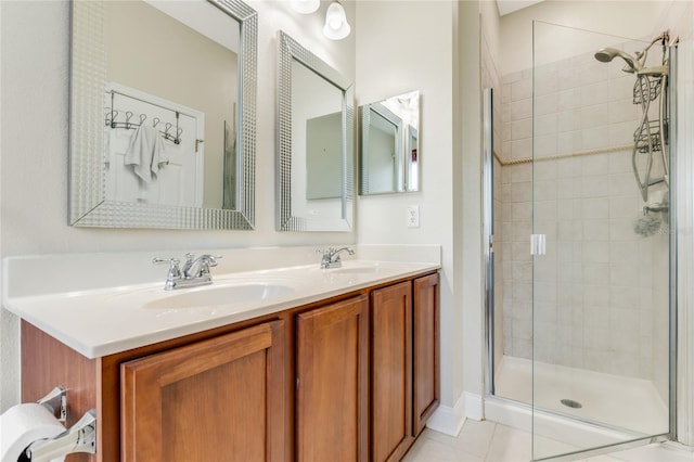 bathroom with an enclosed shower, vanity, and tile patterned flooring