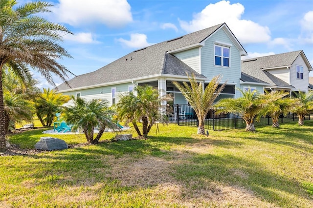 back of property featuring a lawn