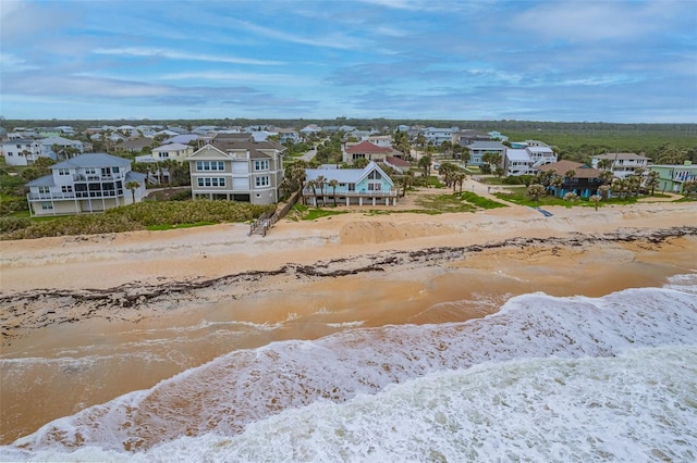 birds eye view of property with a beach view, a residential view, and a water view