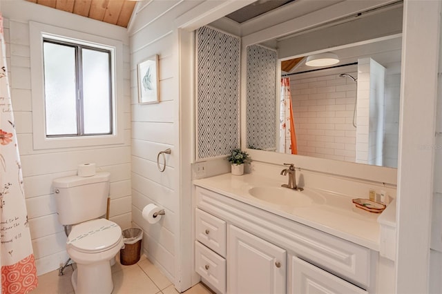 full bathroom featuring toilet, tile patterned floors, curtained shower, and vanity