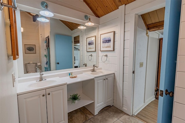 bathroom with double vanity, wooden ceiling, vaulted ceiling, and a sink