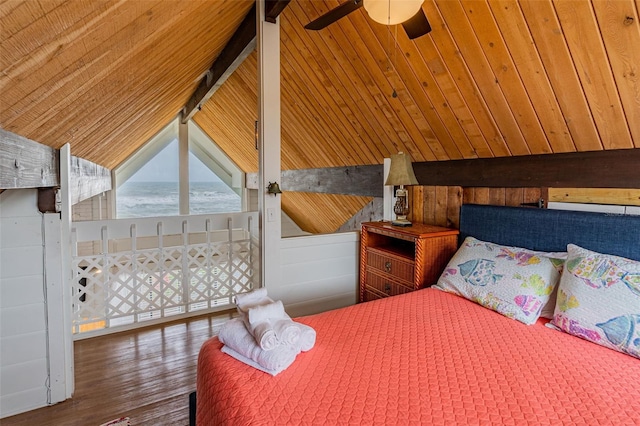 bedroom featuring ceiling fan, vaulted ceiling with beams, wood walls, and wood finished floors