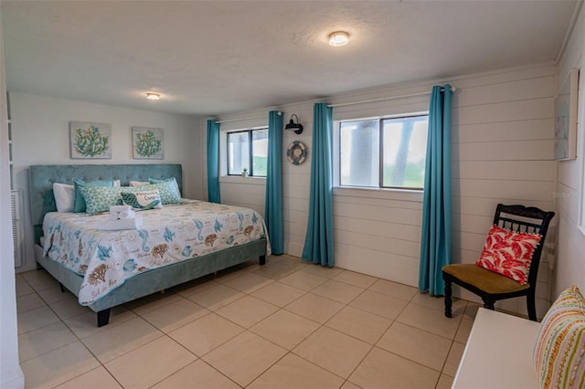 bedroom with a textured ceiling and light tile patterned floors