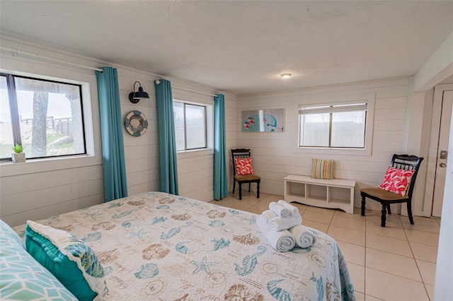 bedroom with light tile patterned floors and multiple windows