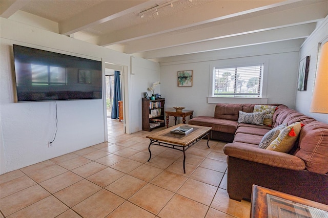 living room with beamed ceiling and light tile patterned floors