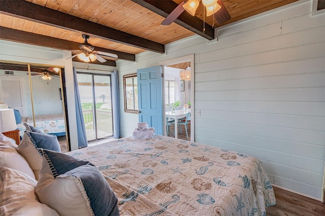 bedroom with beam ceiling, a ceiling fan, wood walls, wood finished floors, and wooden ceiling