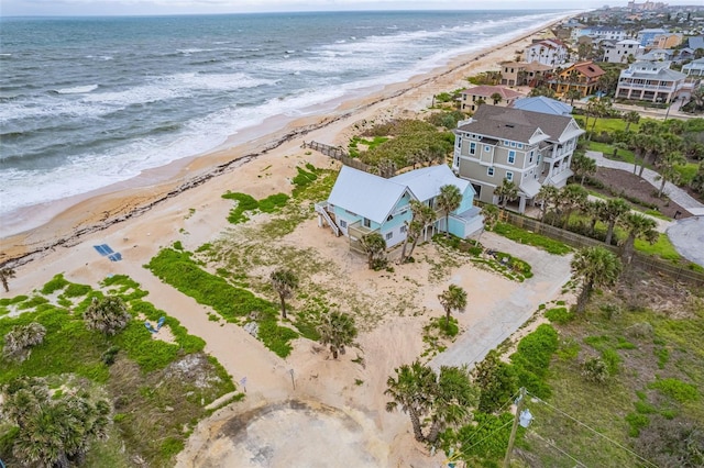 bird's eye view with a water view and a beach view