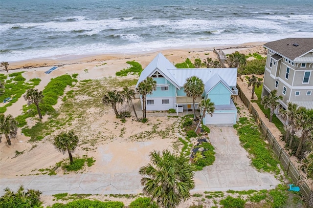 drone / aerial view featuring a water view and a beach view