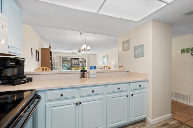 kitchen featuring decorative light fixtures, tile patterned flooring, ceiling fan, kitchen peninsula, and blue cabinetry