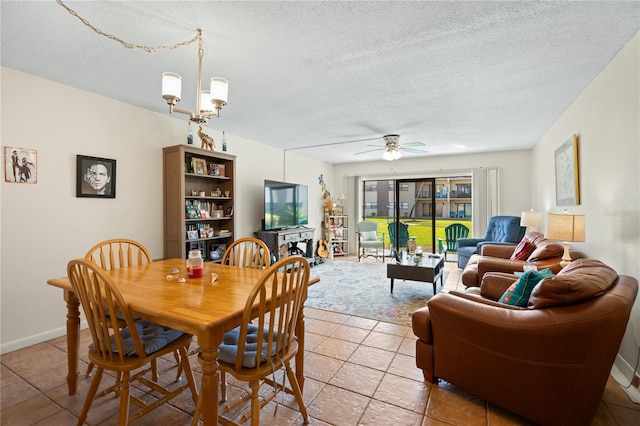 dining room featuring ceiling fan with notable chandelier and a textured ceiling