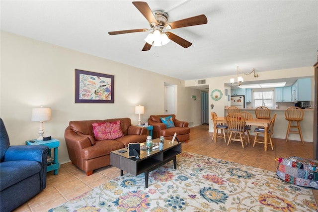 living room featuring ceiling fan and light tile patterned floors