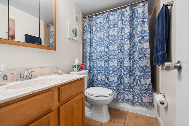 bathroom featuring vanity, toilet, curtained shower, and tile patterned flooring