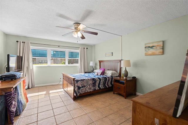 tiled bedroom with ceiling fan and a textured ceiling