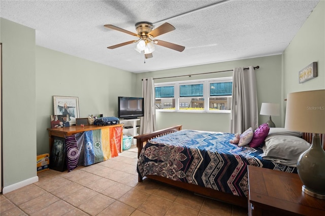 tiled bedroom with ceiling fan and a textured ceiling