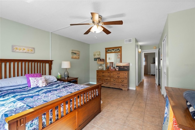 bedroom featuring light tile patterned floors and ceiling fan