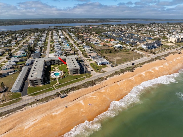 bird's eye view with a water view and a beach view