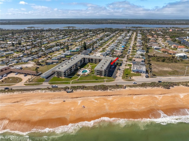 bird's eye view featuring a water view and a view of the beach