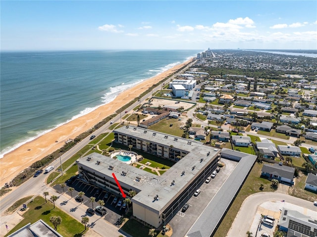 birds eye view of property with a water view and a view of the beach