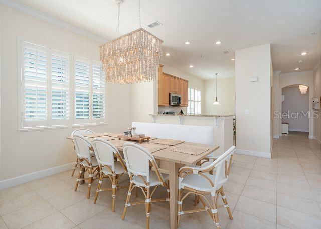 tiled dining room featuring crown molding