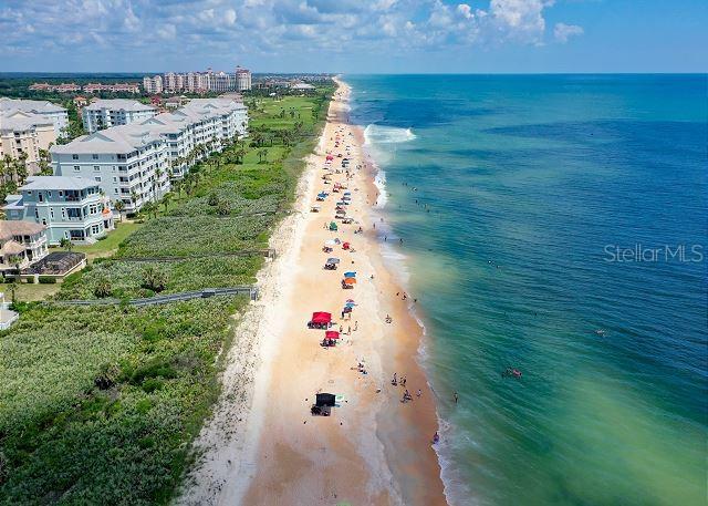 bird's eye view featuring a view of the beach and a water view