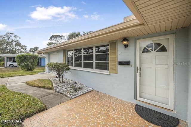 view of exterior entry with a garage