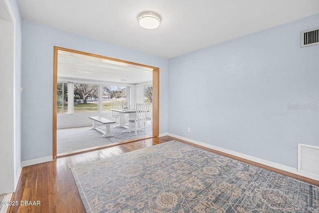 spare room featuring wood-type flooring