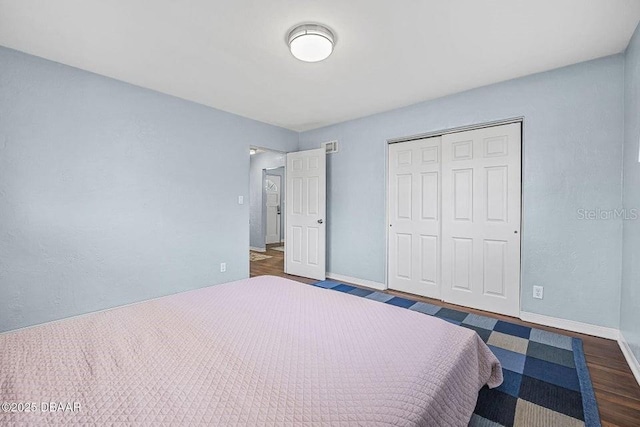 unfurnished bedroom featuring dark hardwood / wood-style flooring and a closet