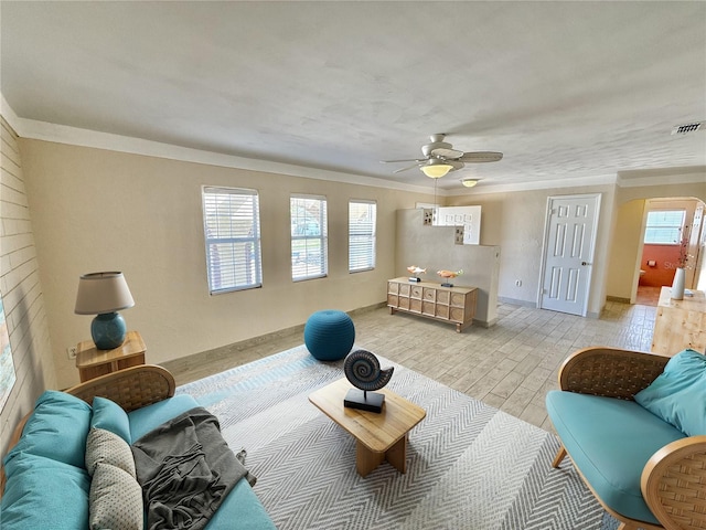 155 Avalon Ave, Flagler Beach, FL 32136 - living room with crown molding, ceiling fan, and light hardwood / wood-style floors