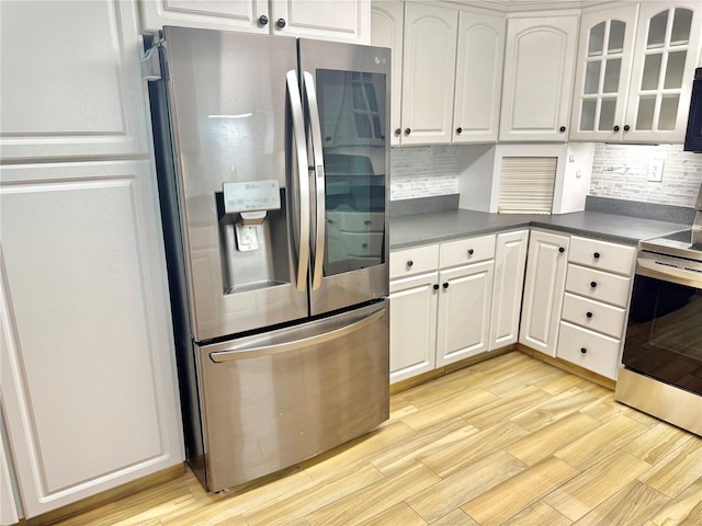 155 Avalon Ave, Flagler Beach, FL 32136 - kitchen featuring white cabinetry, appliances with stainless steel finishes, and light hardwood / wood-style flooring