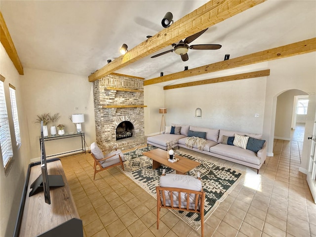 155 Avalon Ave, Flagler Beach, FL 32136 - tiled living room with ceiling fan, a fireplace, and beam ceiling