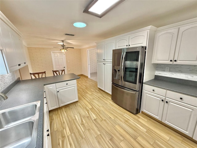 155 Avalon Ave, Flagler Beach, FL 32136 - kitchen featuring sink, white cabinets, stainless steel refrigerator, and light hardwood / wood-style flooring