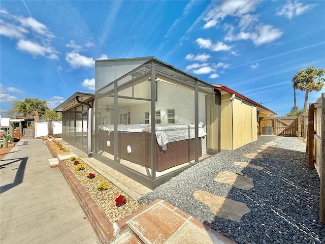155 Avalon Ave, Flagler Beach, FL 32136 - view of side of property with a hot tub and a patio