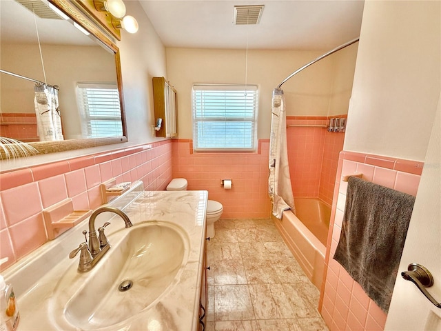 155 Avalon Ave, Flagler Beach, FL 32136 - full bathroom with vanity, tile walls, shower / bath combo with shower curtain, and toilet