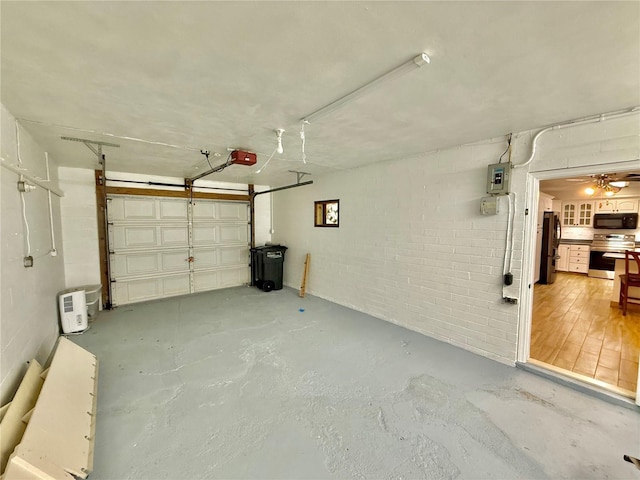 155 Avalon Ave, Flagler Beach, FL 32136 - garage featuring a garage door opener, fridge, and electric panel