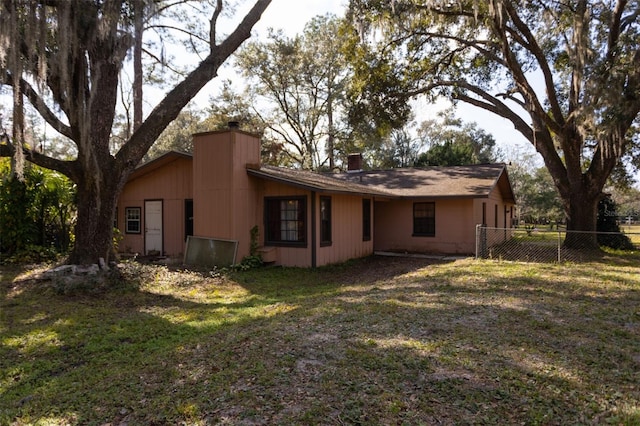 rear view of house with a yard