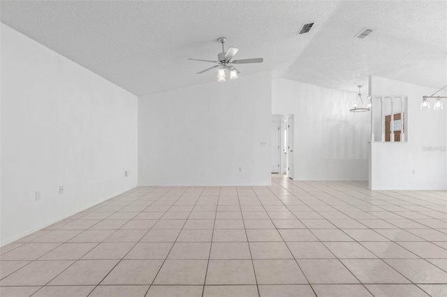 interior space with lofted ceiling, light tile patterned flooring, ceiling fan with notable chandelier, and a textured ceiling
