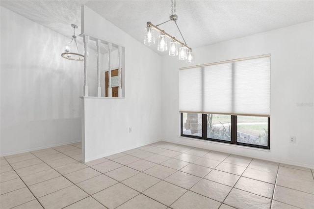 unfurnished room featuring a textured ceiling, an inviting chandelier, and vaulted ceiling